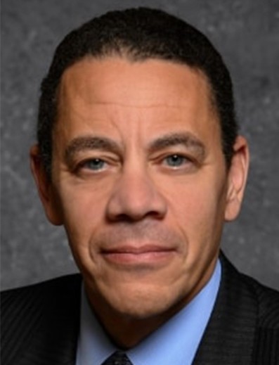 Male employee smiles for camera